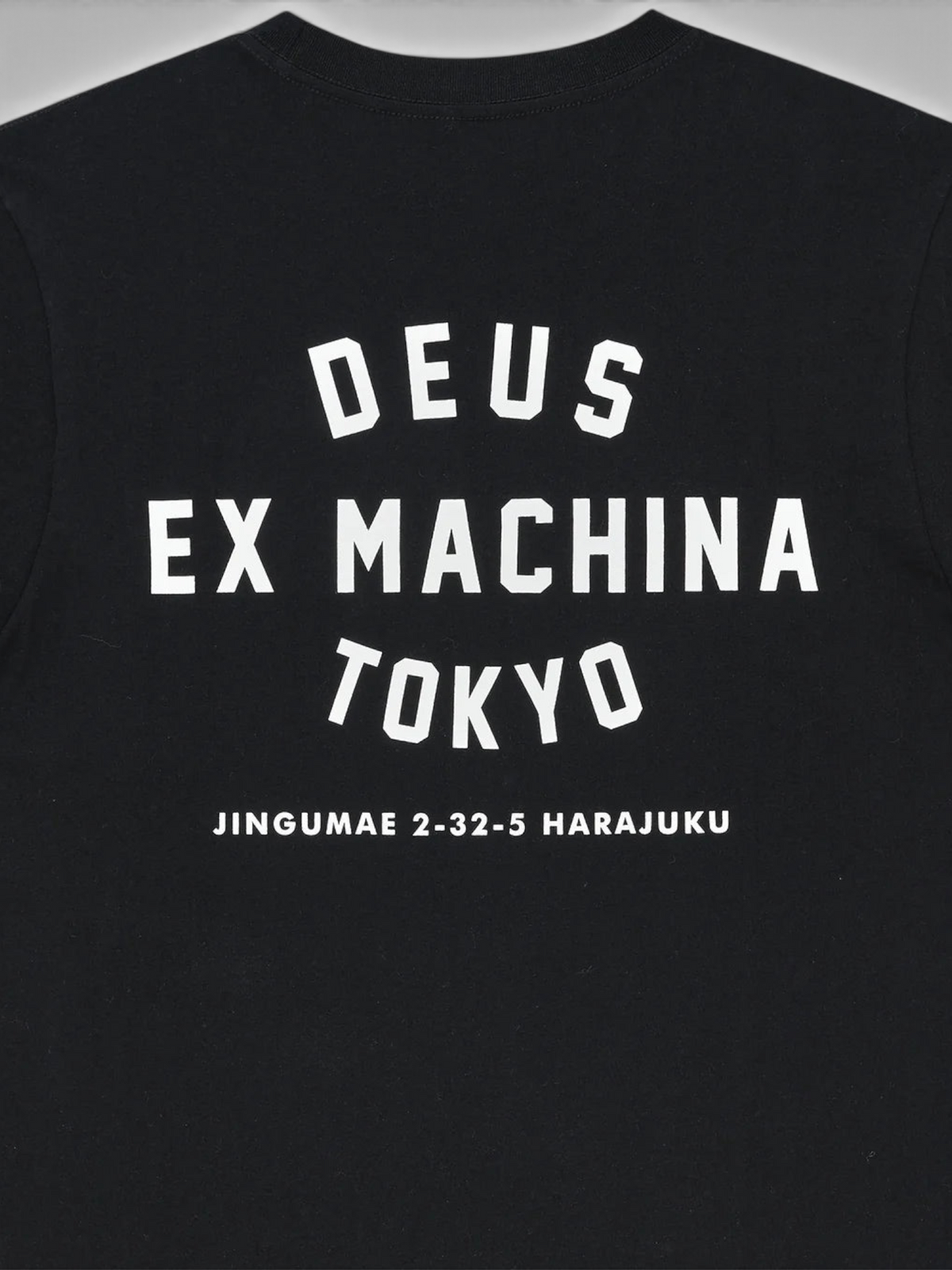 Baffle Haus black organic cotton t-shirt featuring white Deus Ex Machina Tokyo Harajuku back graphic print