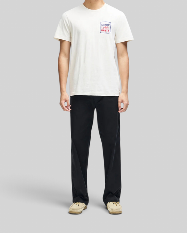 Baffle Haus Mudflap Tee in vintage white organic cotton with a boxy fit and Spare Parts chest graphic