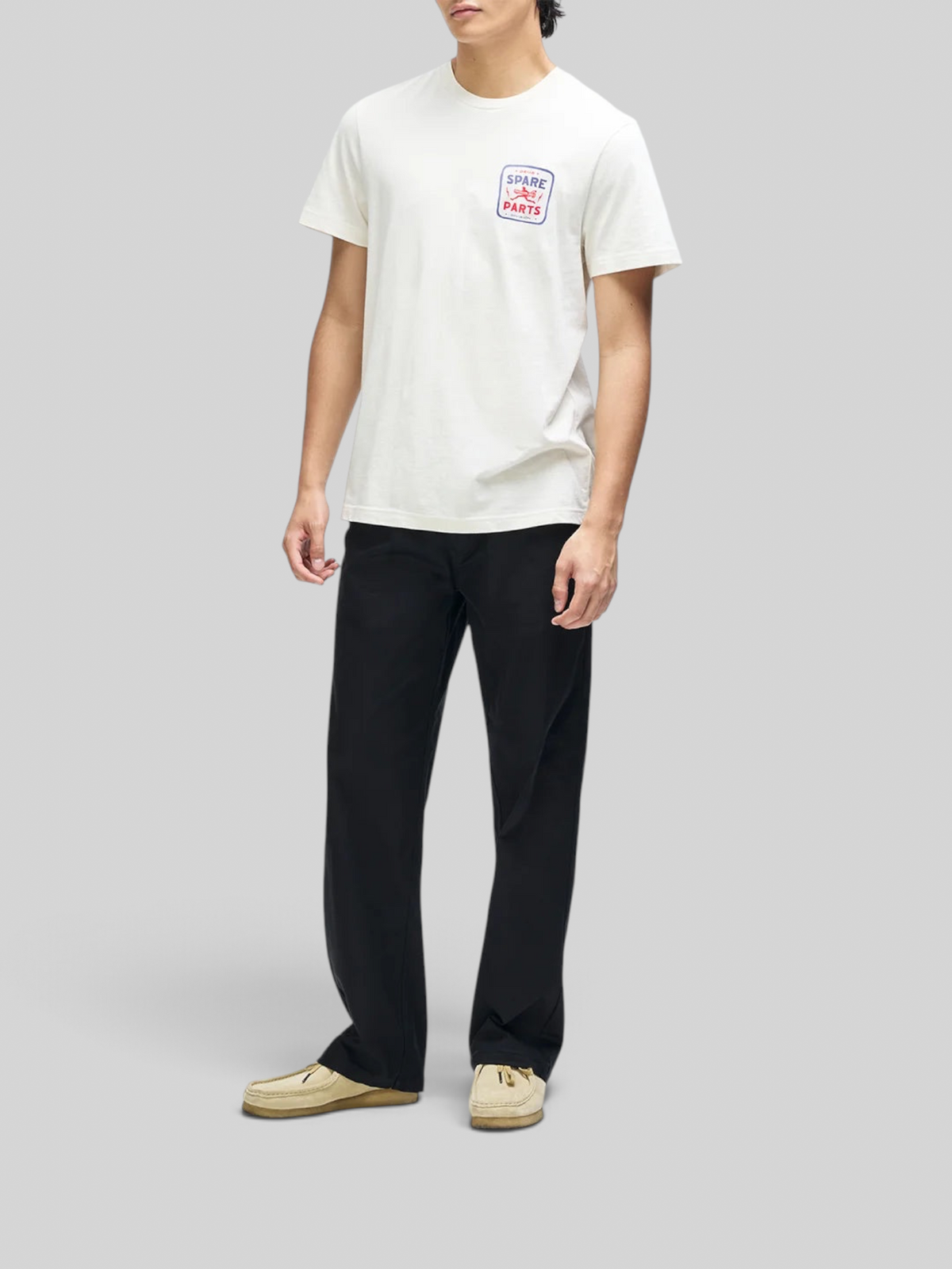 Baffle Haus Mudflap Tee in vintage white organic cotton with a boxy fit and chest graphic print on a male model