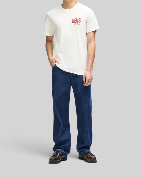 Baffle Haus vintage white box fit organic cotton tee with red chest graphic worn by a man with blue jeans