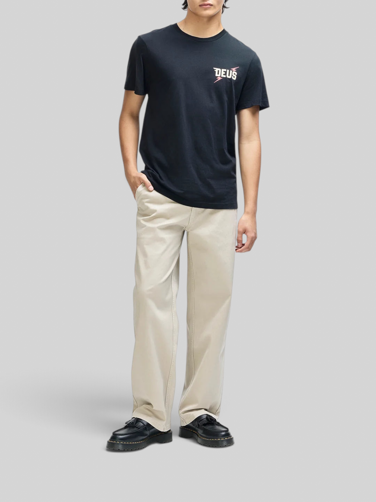 Baffle Haus Global Spark black box fit organic cotton t-shirt with chest graphic worn by a model in beige trousers