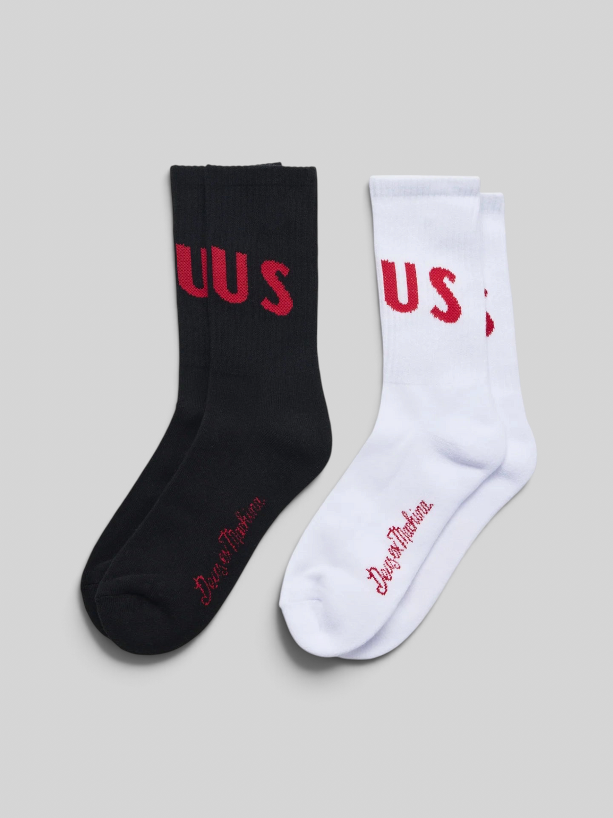 Baffle Haus Ranger crew socks in a 2-pack featuring one black and one white pair with red jacquard knit branding.