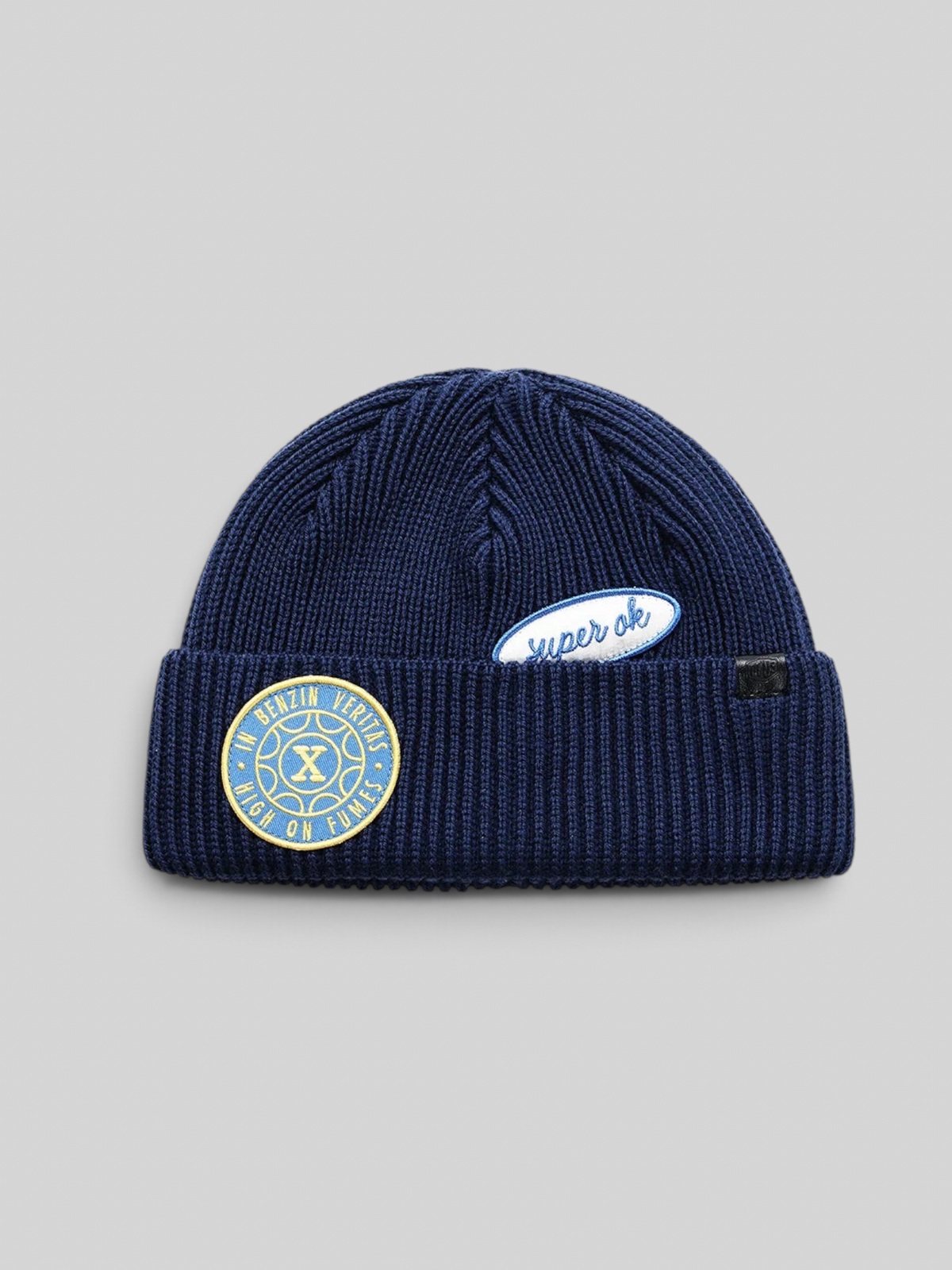 Baffle Haus Trophy Beanie in pageant blue merino wool with fisherman fit and decorative chenille patches.