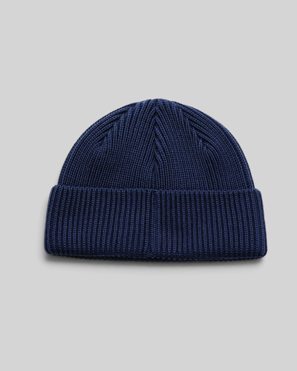Baffle Haus Trophy Beanie in pageant blue merino wool with a fisherman fit and ribbed knit texture.
