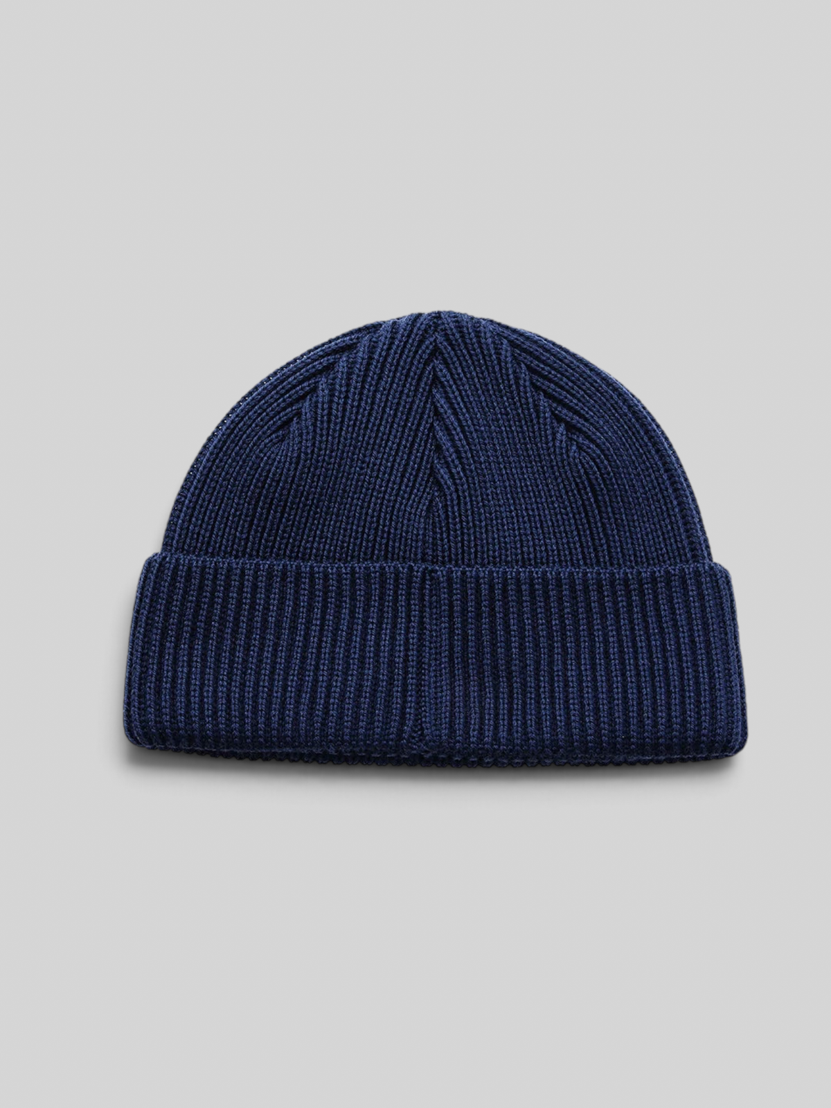 Baffle Haus Trophy Beanie in pageant blue merino wool with a fisherman fit and ribbed knit texture.