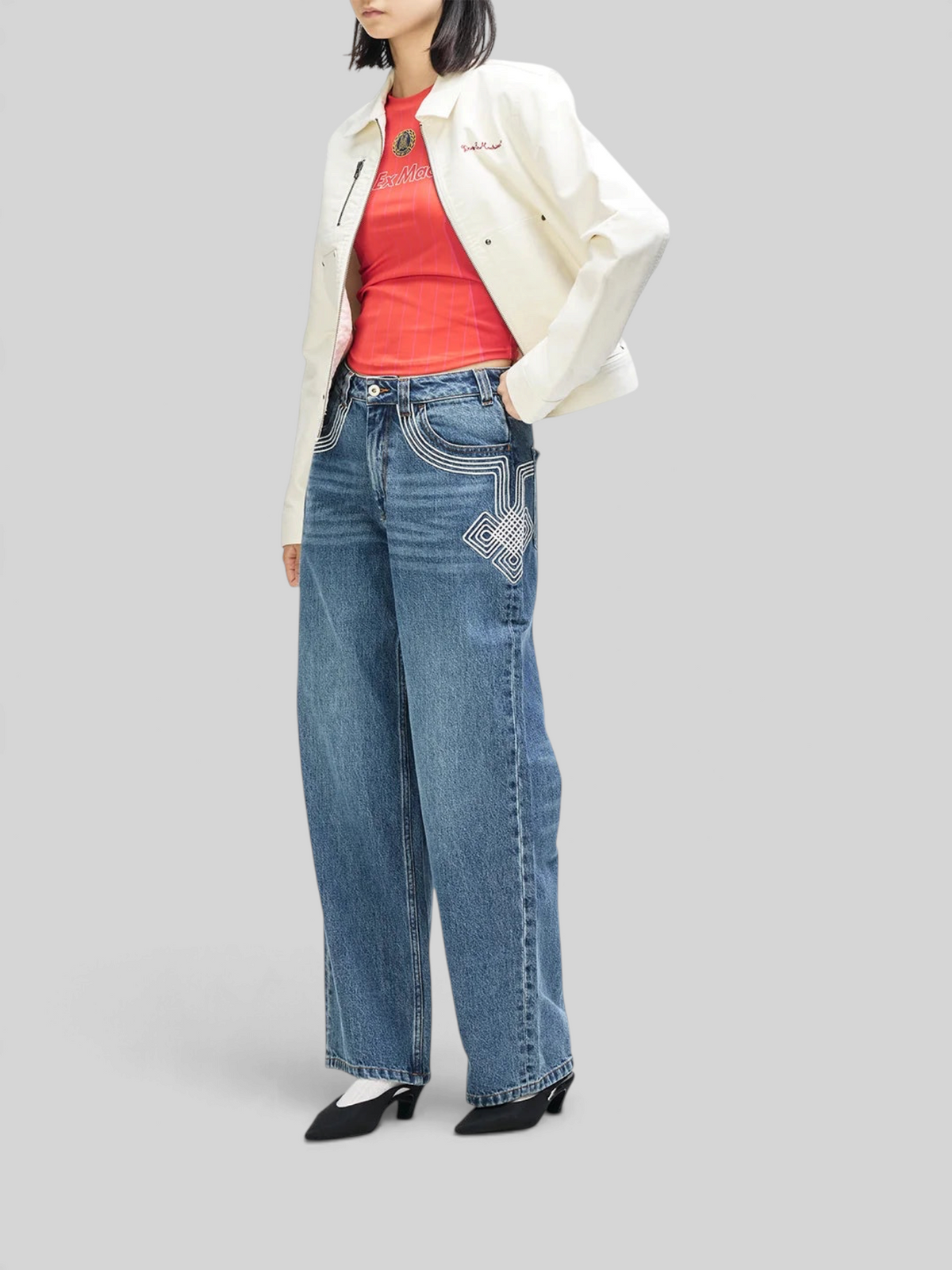 Baffle Haus Trophy Jacket in whisper white cotton moleskin worn over a red top and wide-leg denim jeans