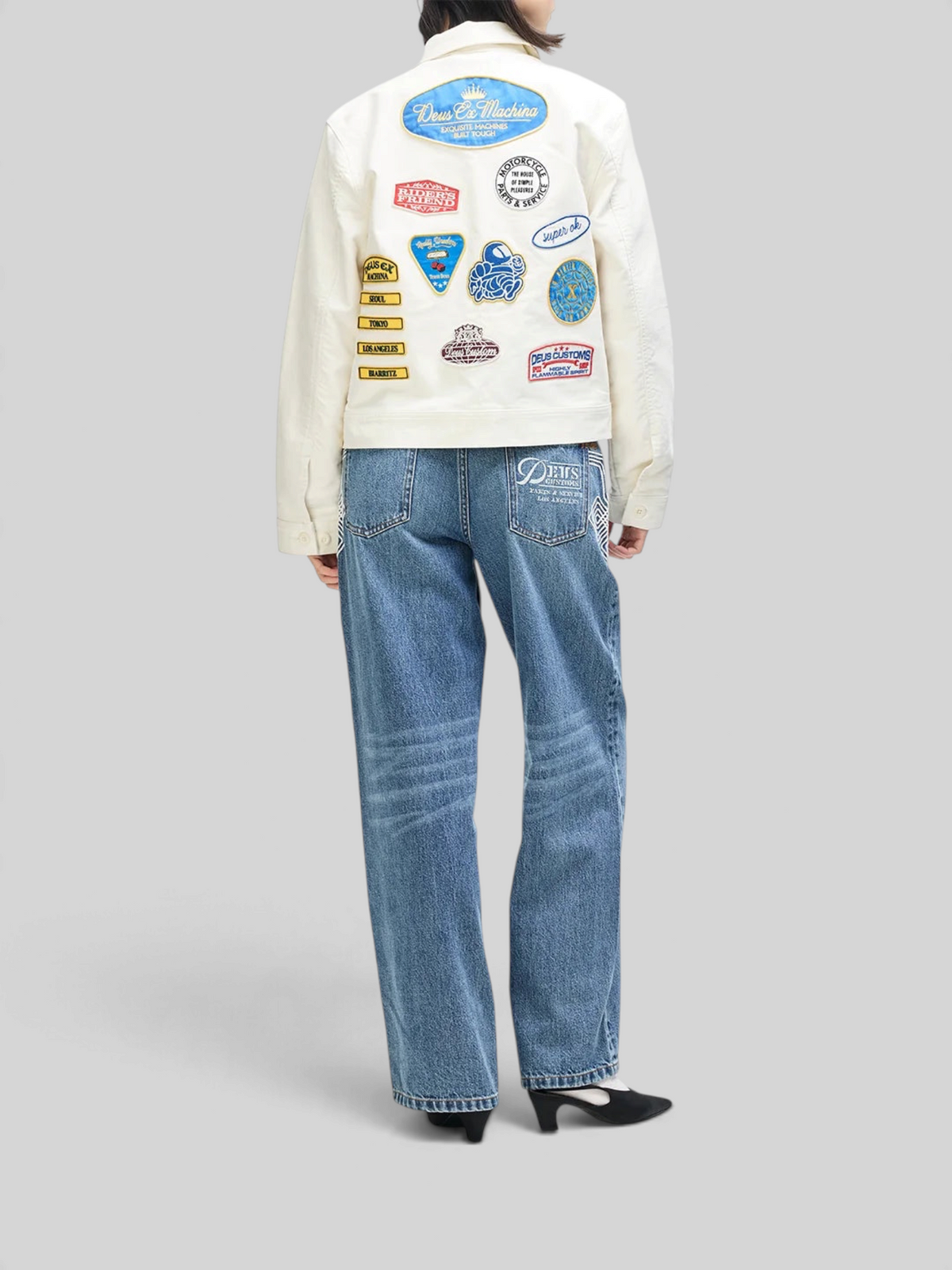 Baffle Haus Trophy Jacket in whisper white cotton moleskin featuring colorful vintage-style patches on the back