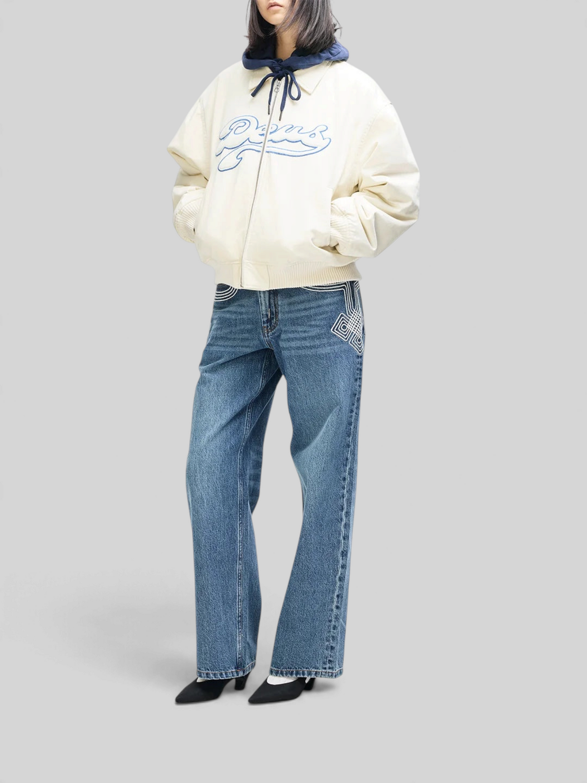 Baffle Haus Runner-Up jacket in whisper white cotton twill with blue velvet applique, worn over blue denim jeans.