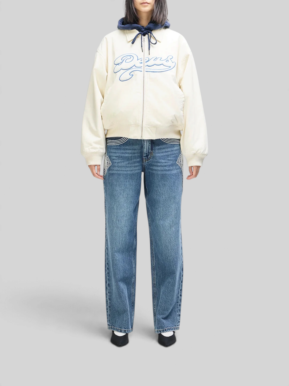 Baffle Haus Runner-Up jacket in whisper white cotton twill with blue Deus velvet applique and ribbed cuffs.