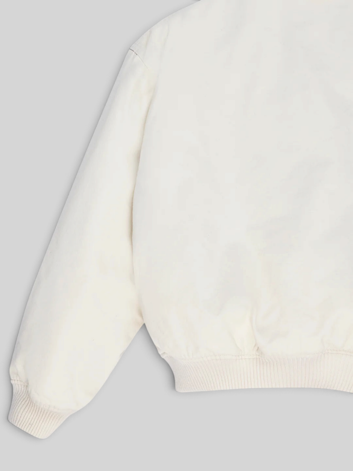 Baffle Haus Runner-Up jacket in whisper white cotton twill with ribbed cuffs and hem, back view.