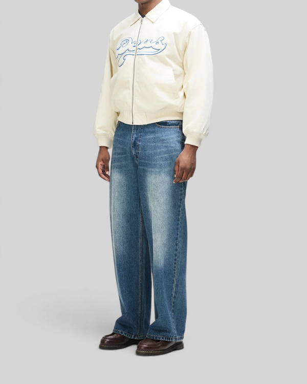 Baffle Haus Runner-Up jacket in whisper white cotton twill with blue velvet applique, worn with blue denim jeans.
