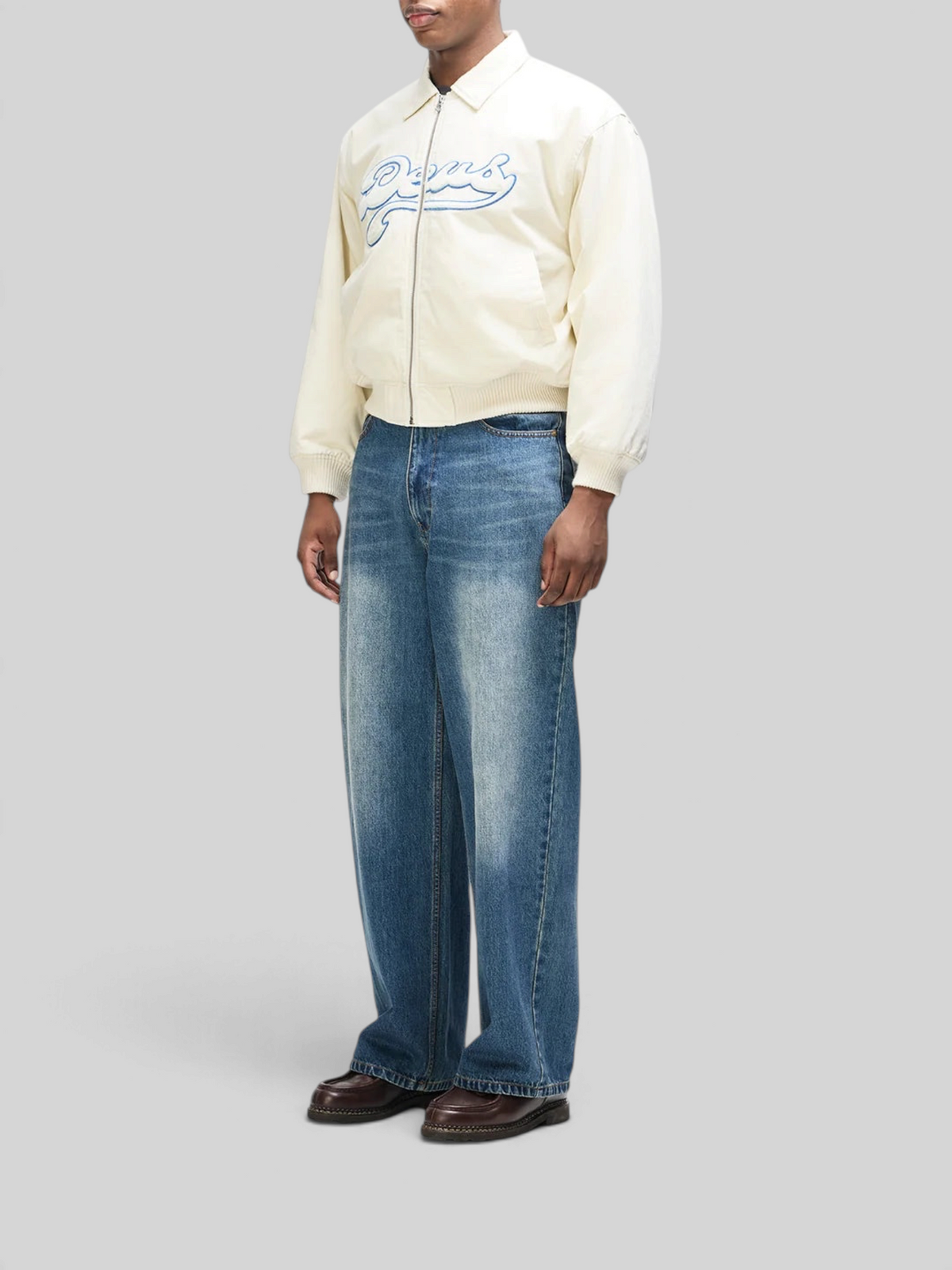 Baffle Haus Runner-Up jacket in whisper white cotton twill with blue velvet applique, worn with blue denim jeans.
