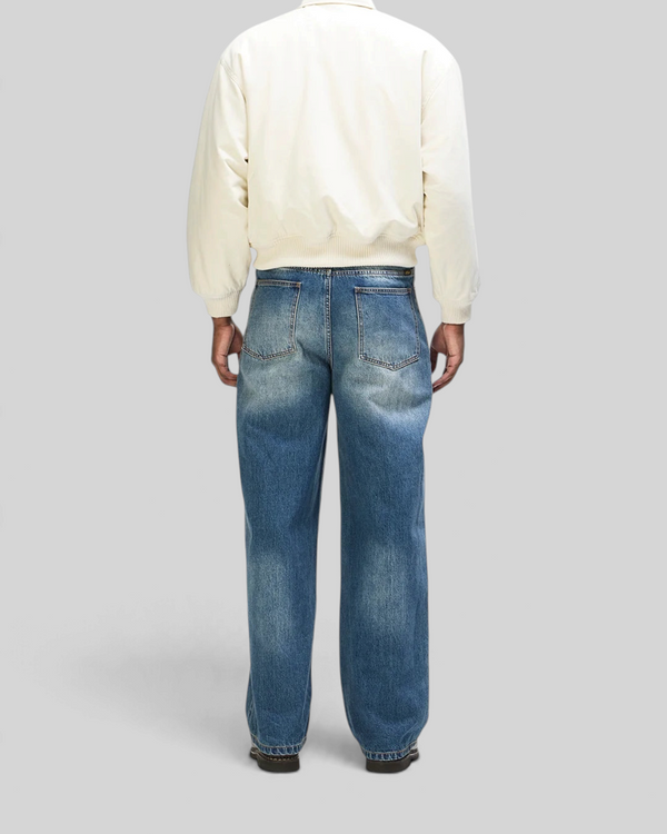 Baffle Haus Runner-Up jacket in whisper white cotton twill with ribbed cuffs and hem, worn with blue denim jeans