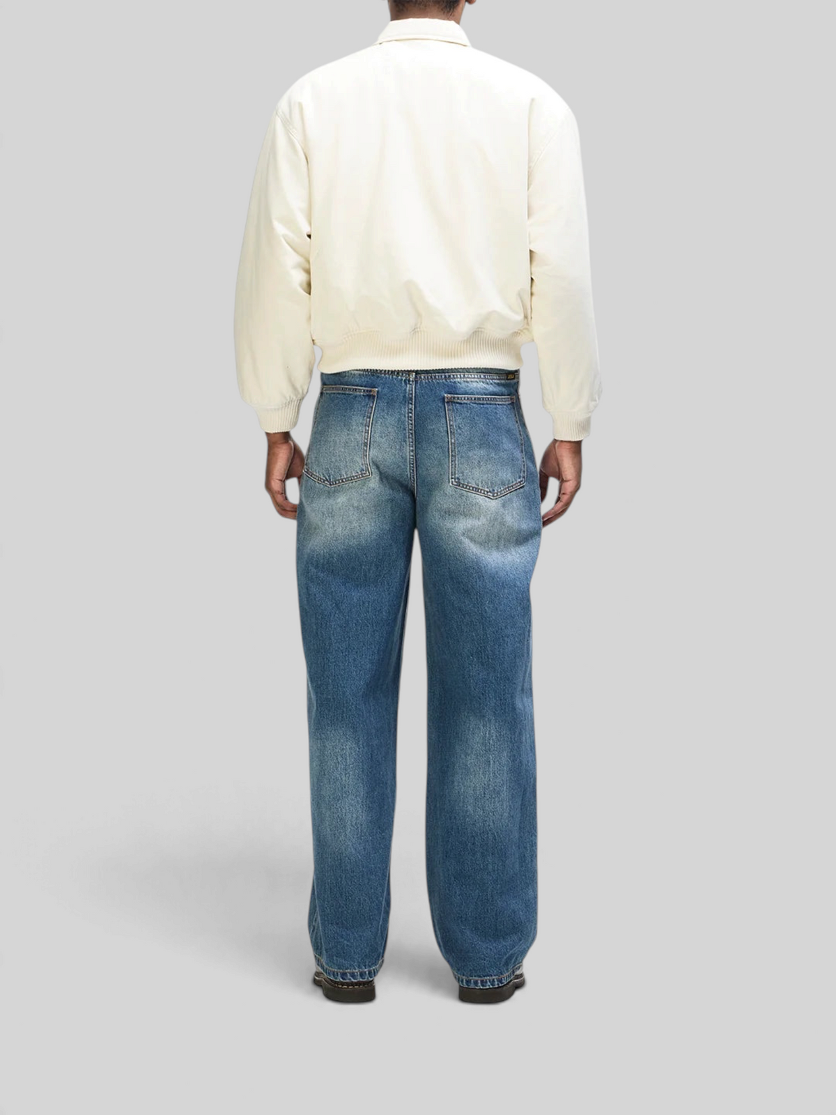 Baffle Haus Runner-Up jacket in whisper white cotton twill with ribbed cuffs and hem, worn with blue denim jeans