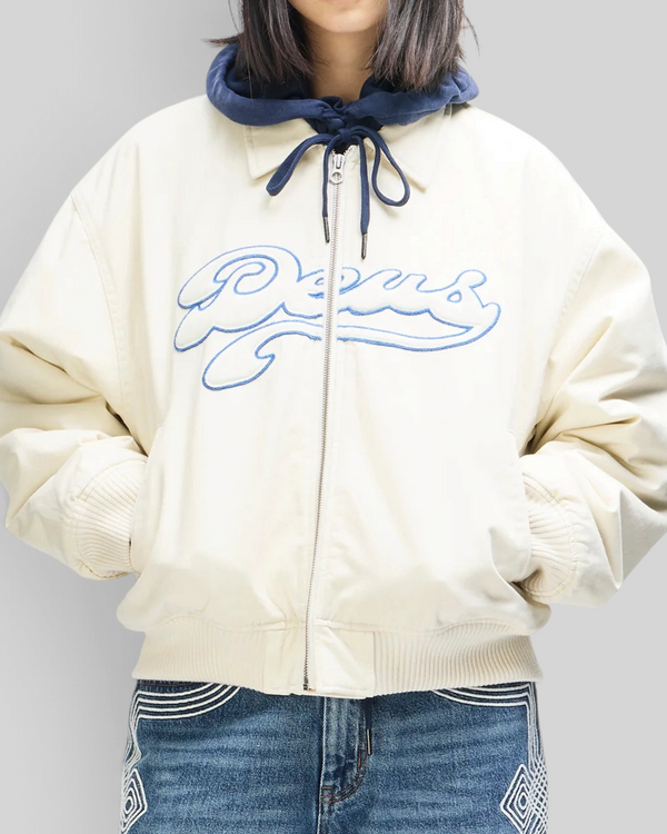 Baffle Haus Runner-Up jacket in whisper white cotton twill with blue Deus velvet applique and ribbed cuffs