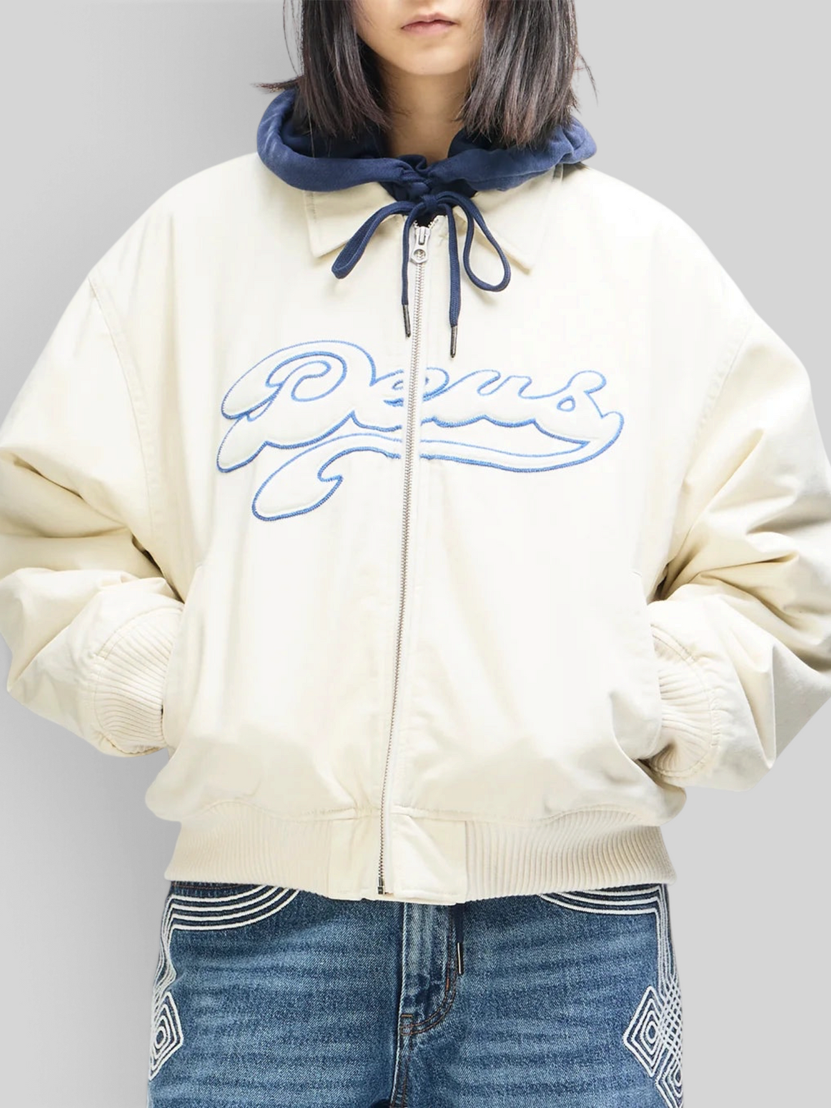 Baffle Haus Runner-Up jacket in whisper white cotton twill with blue Deus velvet applique and ribbed cuffs
