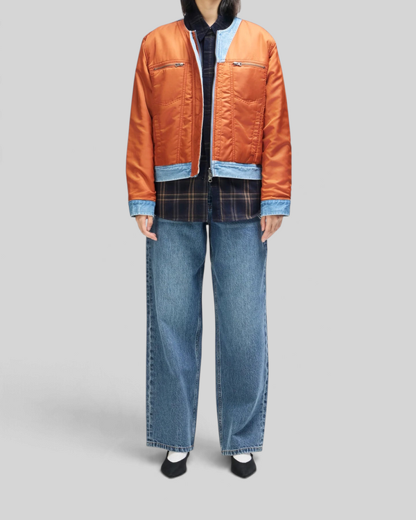 Baffle Haus Br 163 reversible jacket in rust nylon and indigo denim worn over a plaid shirt and wide-leg jeans