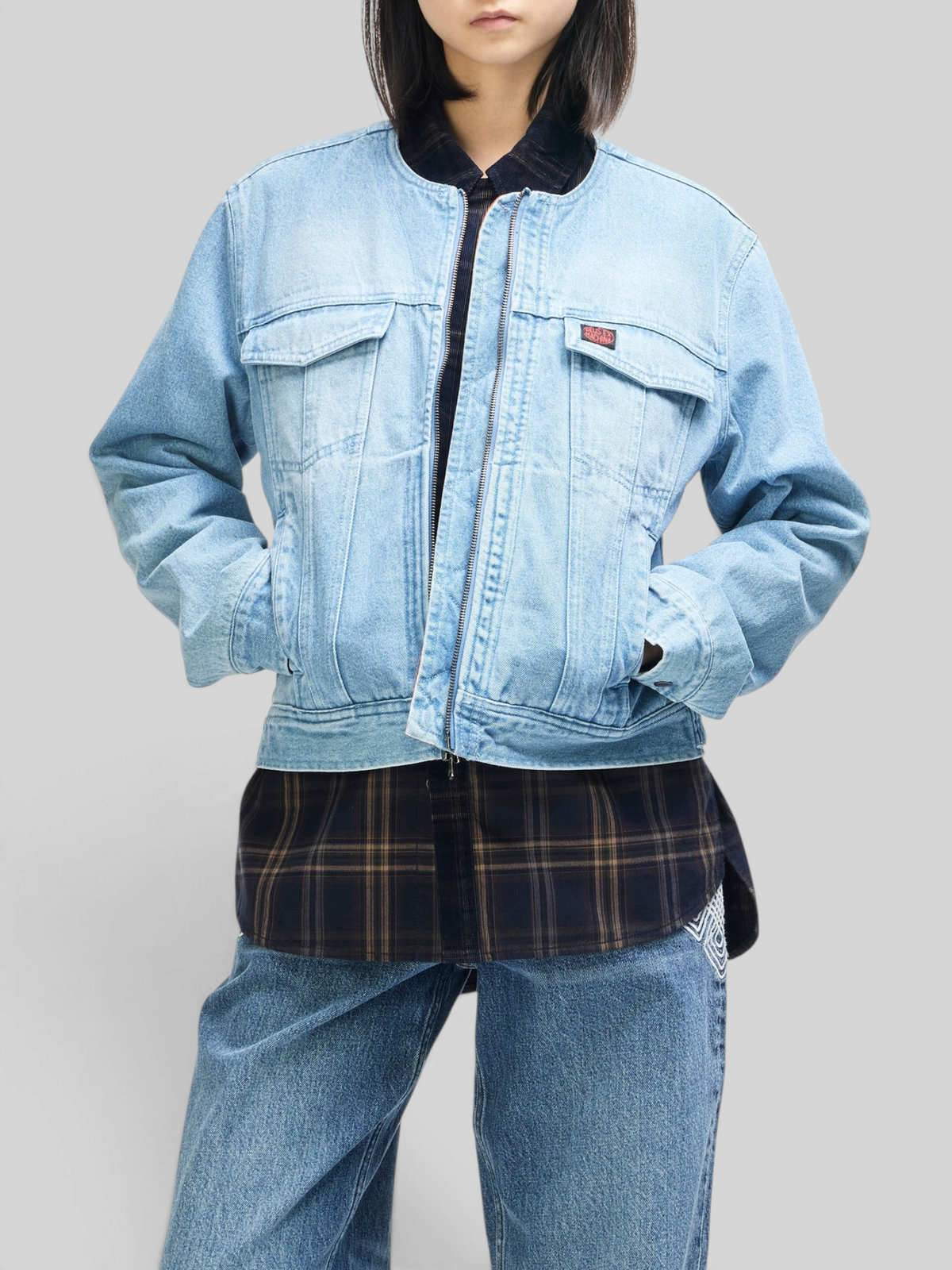 Baffle Haus Br 163 reversible light wash denim jacket with double zip closure worn over a plaid shirt