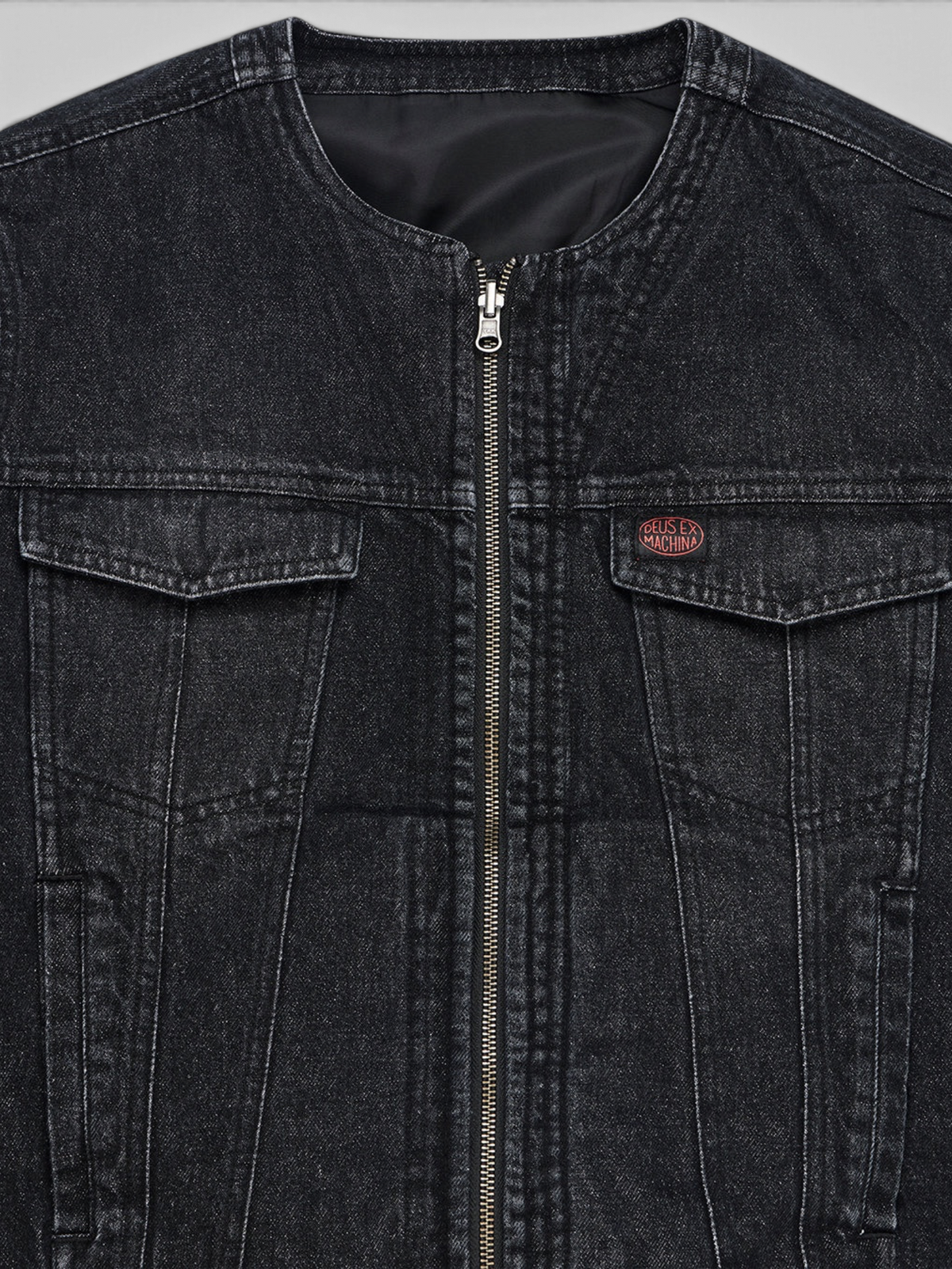 Baffle Haus Br 163 reversible black denim jacket featuring a front zip closure and Deus Ex Machina chest patch.