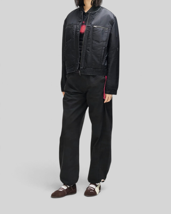 Baffle Haus Br 163 reversible black nylon and denim jacket worn by a model with zip pockets and ribbed collar