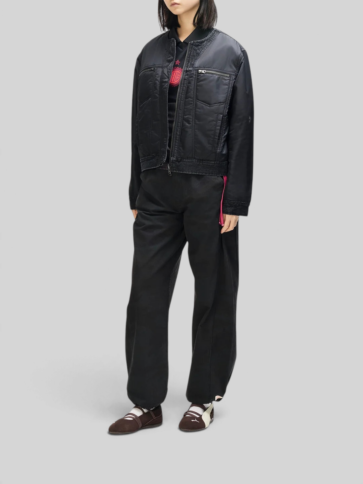 Baffle Haus Br 163 reversible black nylon and denim jacket worn by a model with zip pockets and ribbed collar