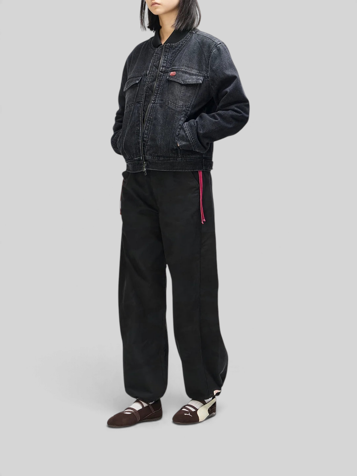 Baffle Haus Br 163 reversible phantom-black denim jacket worn by a model with black trousers and flat shoes.