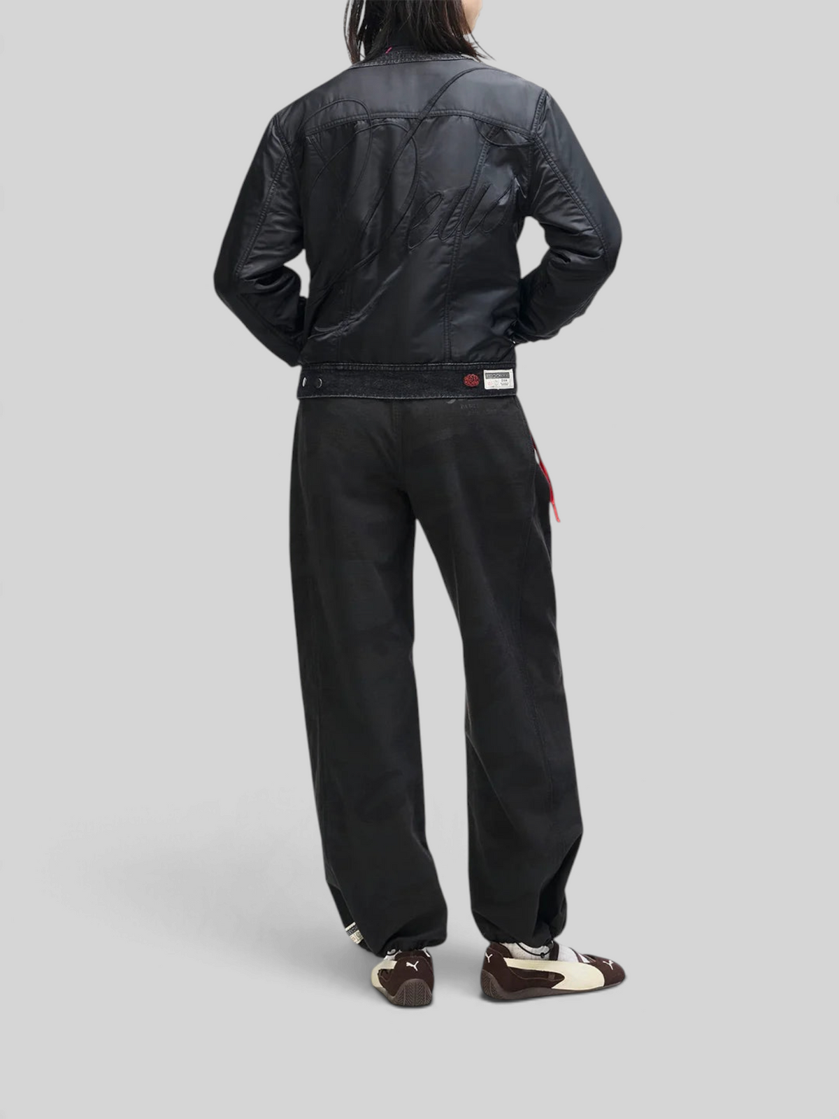 Baffle Haus Br 163 reversible black nylon jacket with back embroidery worn by a model from the back view