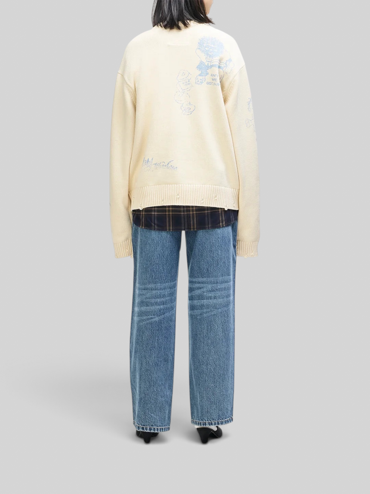 Baffle Haus oversized cream cotton knit crew sweater with blue graphic prints and distressed hem details, back view.