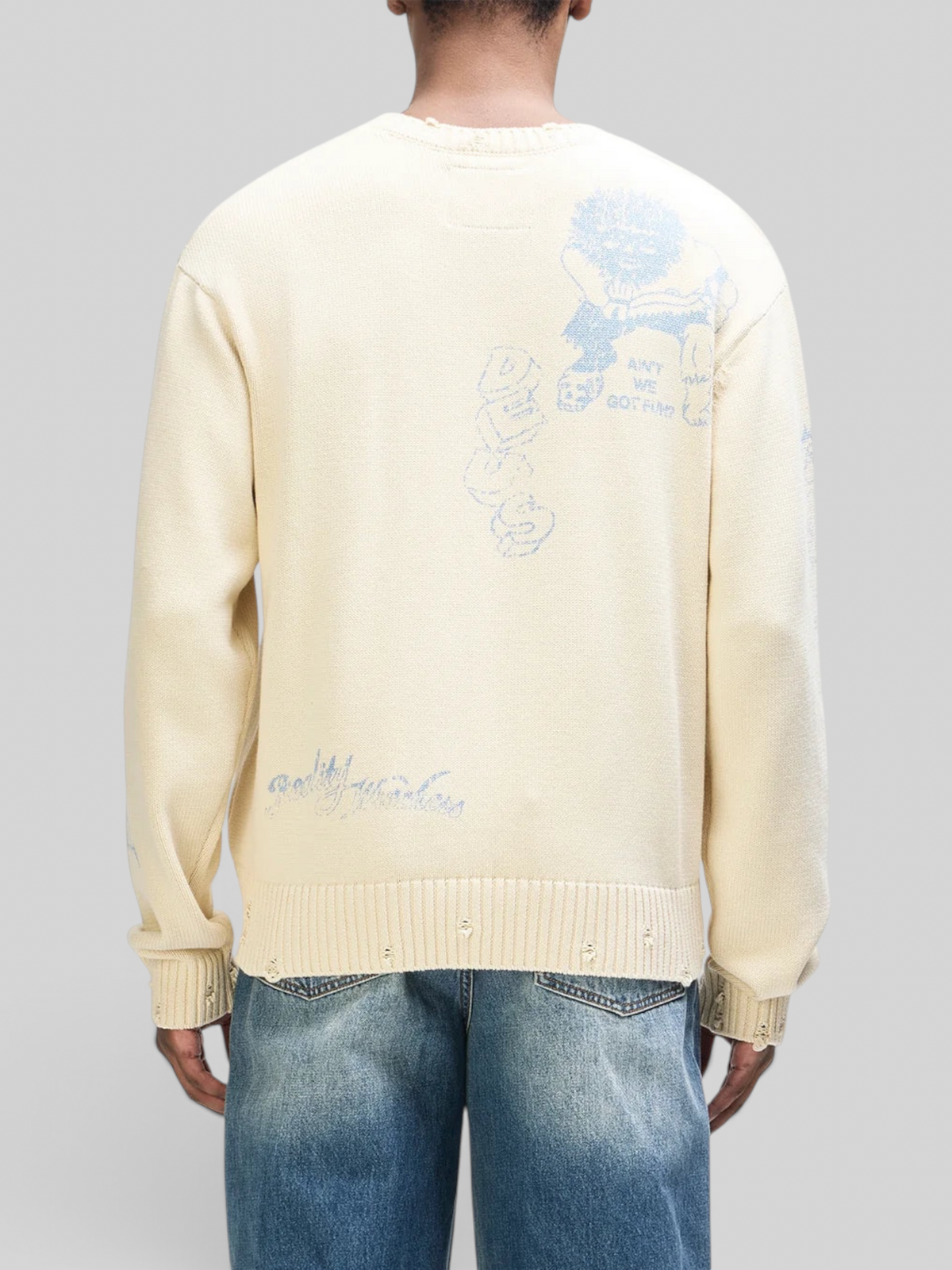 Back view of Baffle Haus cream cotton knit crew sweater with blue graphic artwork and distressed hem and neck details.