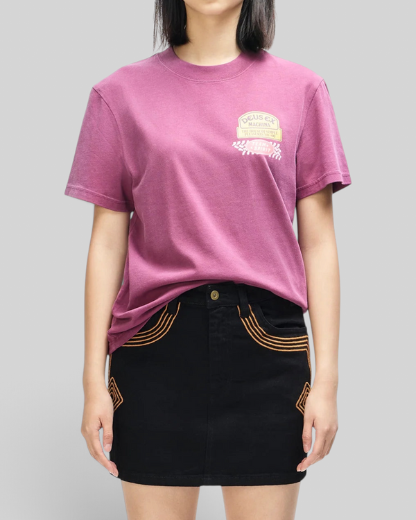 Baffle Haus Daphne Tee in pigment-dyed burgundy recycled cotton with a small Deus Ex Machina chest pocket print.