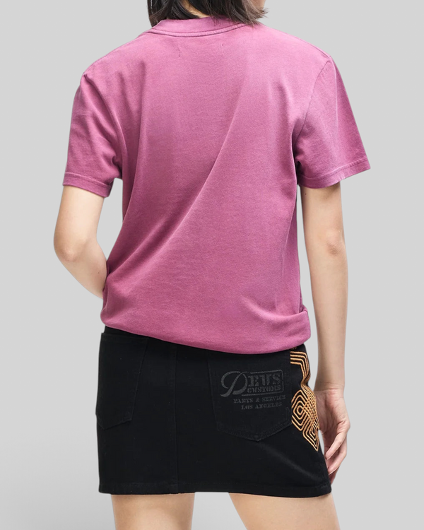 Baffle Haus Daphne Tee in burgundy pigment-dyed cotton, worn by a model from the back, showing a slim fit.