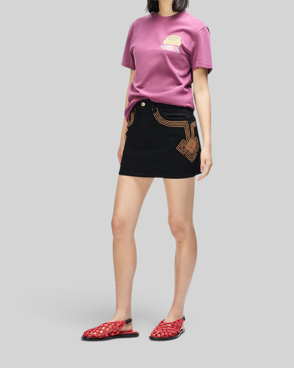 Baffle Haus Daphne burgundy slim fit cotton tee with chest pocket print worn with a black embroidered mini skirt