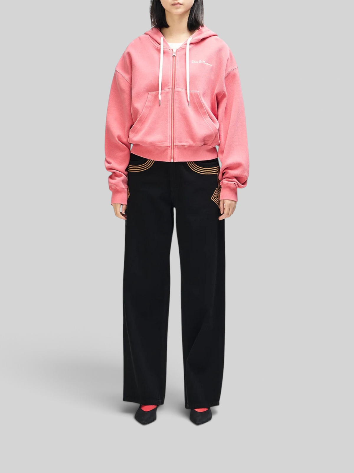 Baffle Haus Poinsettia Red waffle knit zip-up hoodie with white drawstrings and chest embroidery on a model