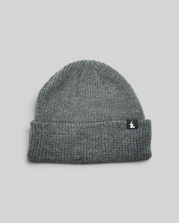 Baffle Haus grey acrylic knit beanie with a folded cuff and small woven brand label on a white background.