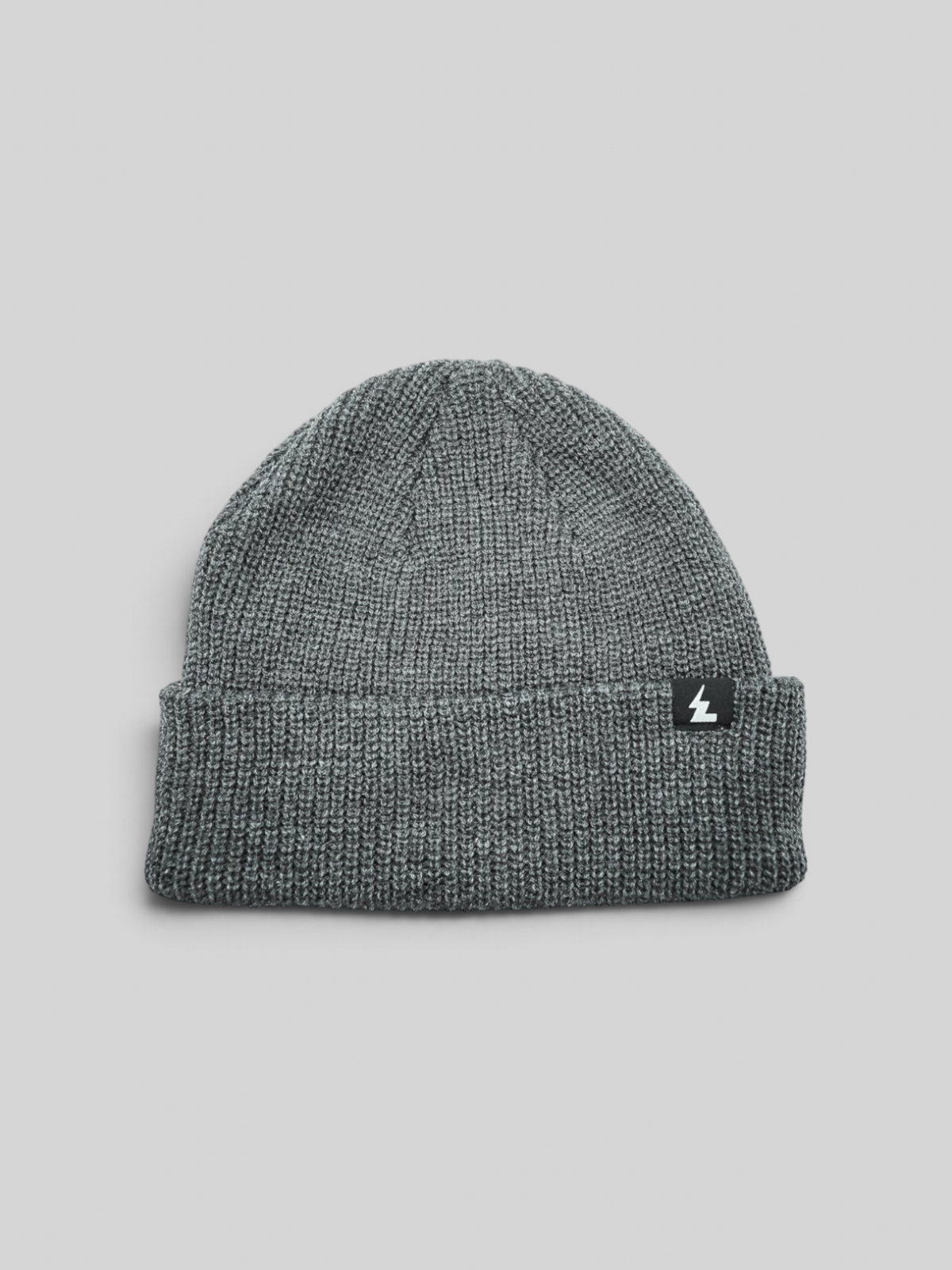 Baffle Haus grey acrylic knit beanie with a folded cuff and small woven brand label on a white background.