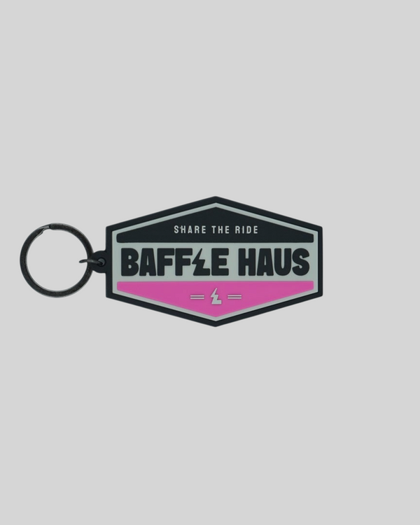 Baffle Haus retro key tag in pink and black embossed PVC with a durable split-ring keyring attachment.