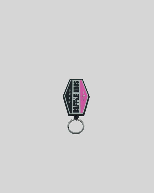 Baffle Haus pink retro key tag made of durable embossed PVC with a debossed logo and metal split-ring attachment.