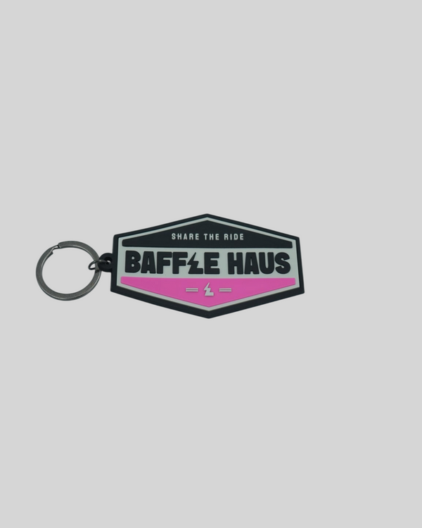 Baffle Haus retro key tag in pink and black embossed PVC with a durable split-ring keyring attachment.