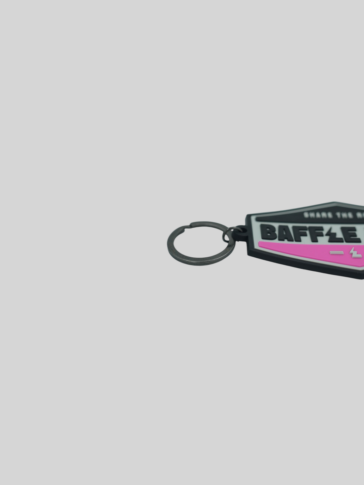 Baffle Haus pink retro key tag with embossed logo and durable PVC construction on a light grey background