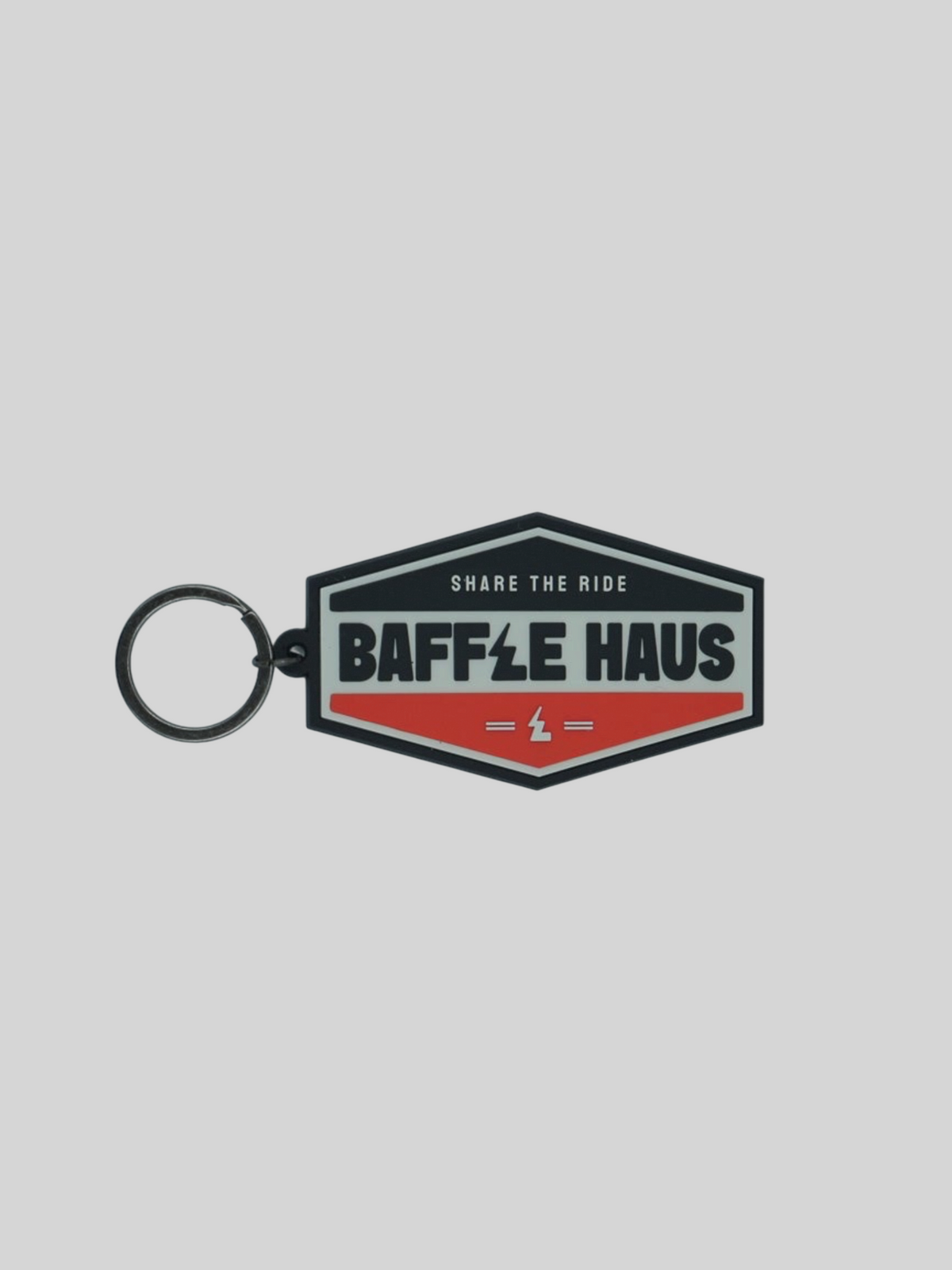 Baffle Haus orange retro key tag with embossed logo and durable PVC construction on a plain background