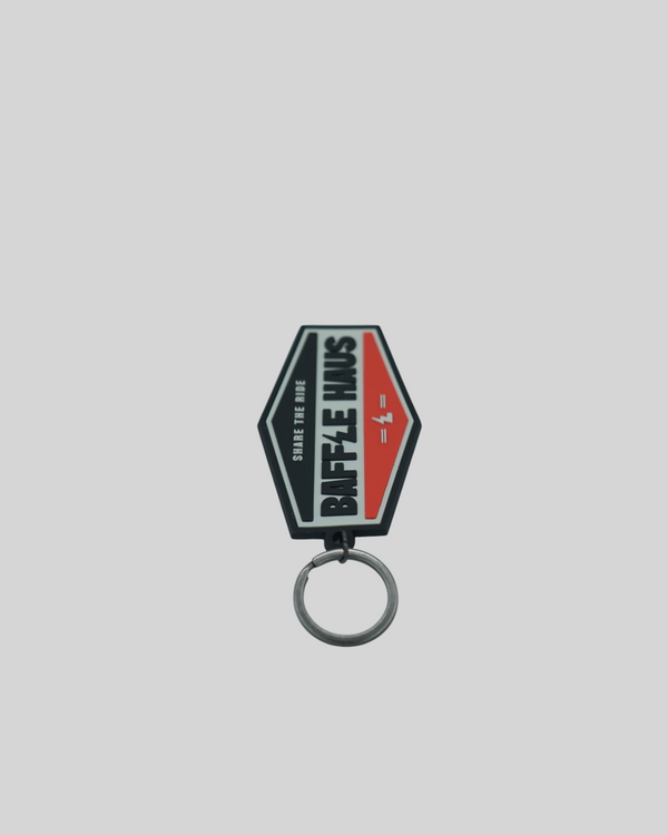Baffle Haus orange retro key tag made of durable embossed PVC with a debossed logo and metal split-ring keyring.
