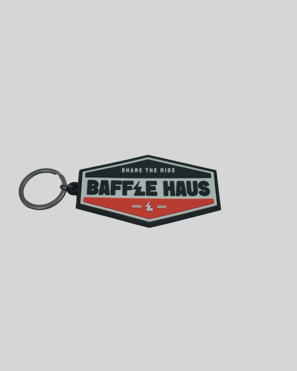 Baffle Haus orange and black embossed PVC retro key tag with debossed logo and metal split-ring
