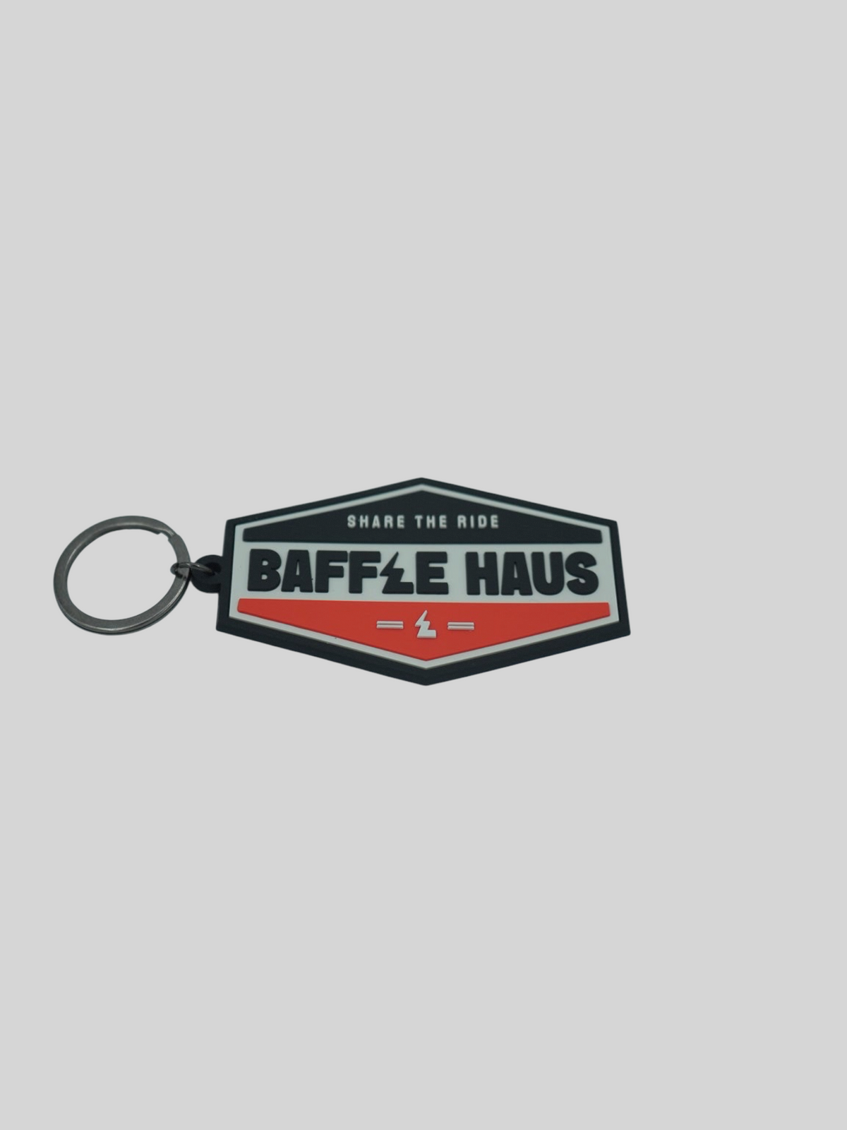 Baffle Haus orange and black embossed PVC retro key tag with debossed logo and metal split-ring
