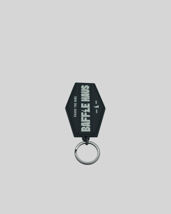 Baffle Haus black embossed PVC retro key tag with debossed logo and metal split-ring keyring.