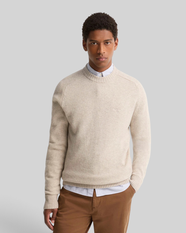 Baffle Haus Barbour light grey lambswool crew neck jumper with ribbed cuffs and chest embroidery on a male model