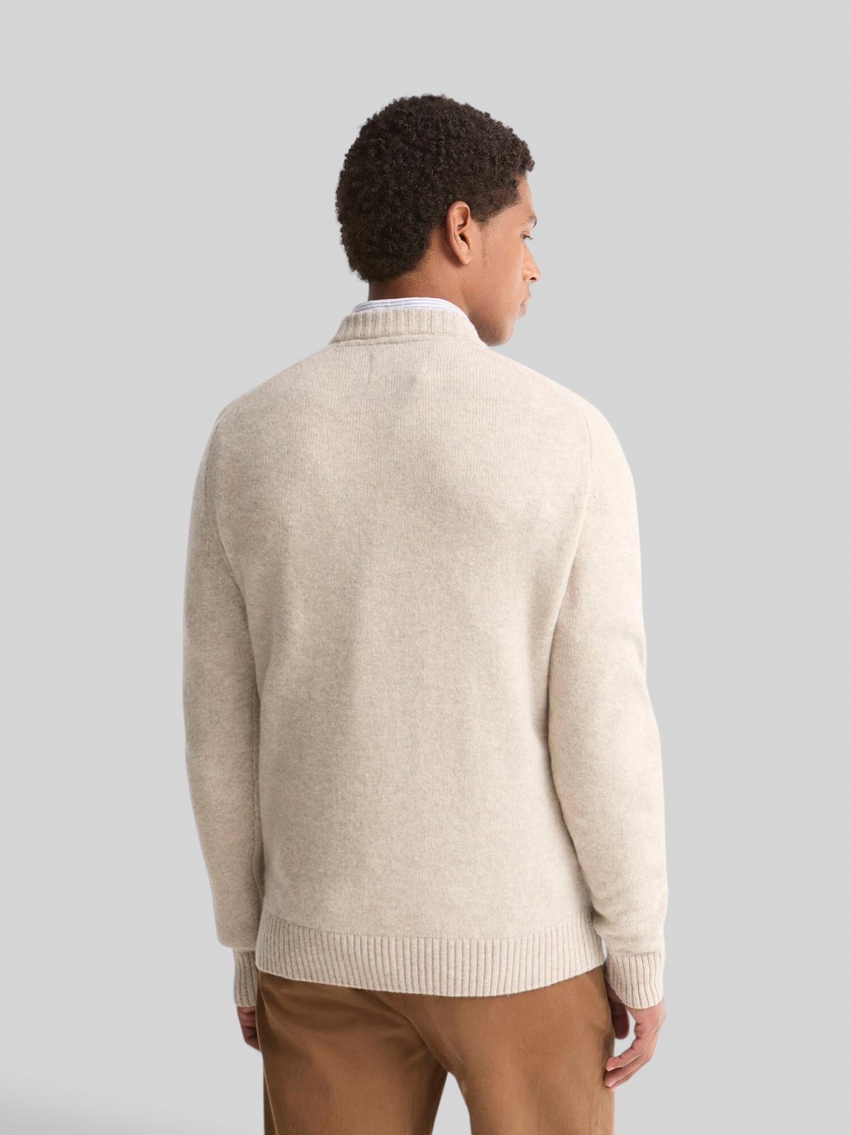Baffle Haus Barbour light grey lambswool crew neck jumper worn by a man, back view showing ribbed hem and collar