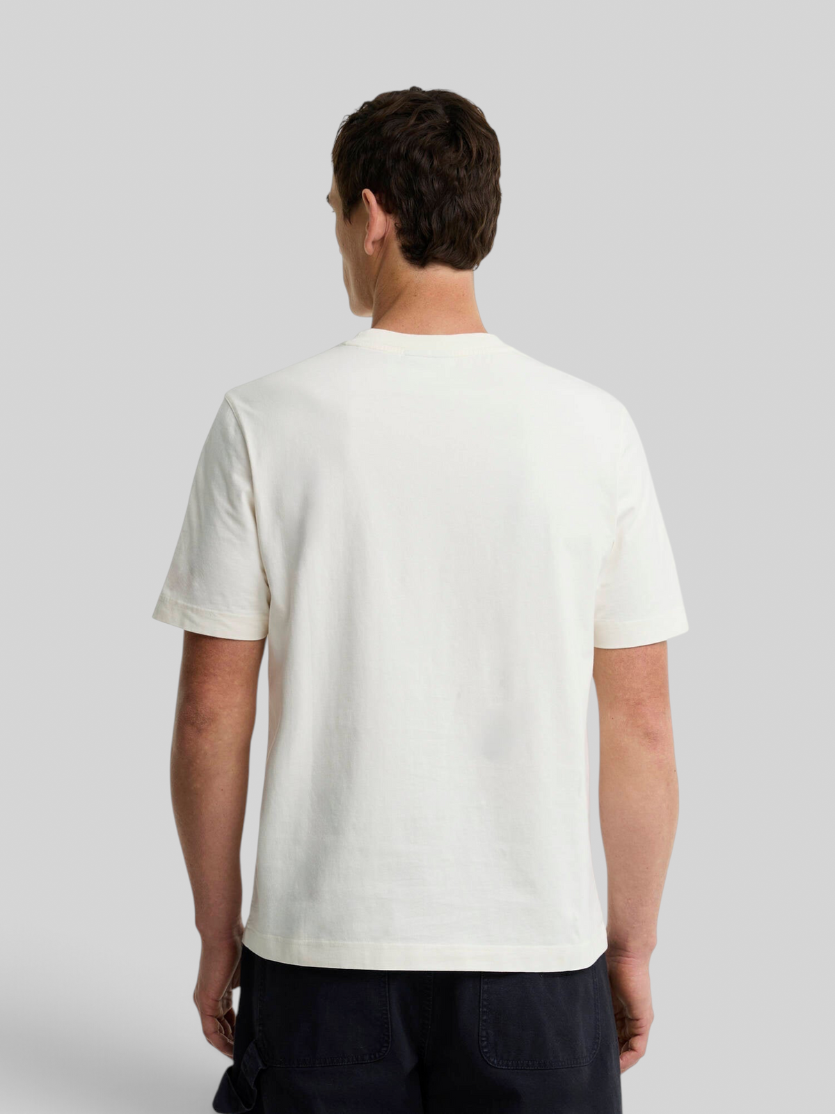 Back view of a man wearing a Baffle Haus Barbour Wadsworth relaxed fit whisper white cotton t-shirt