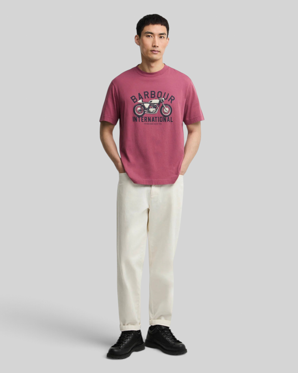 Baffle Haus maroon cotton t-shirt with motorcycle graphic print on chest worn by a man with cream trousers