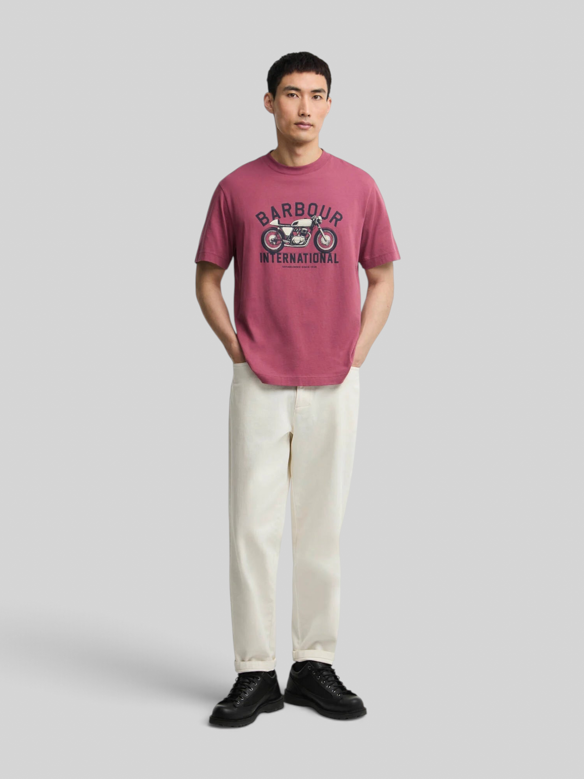 Baffle Haus maroon cotton t-shirt with motorcycle graphic print on chest worn by a man with cream trousers