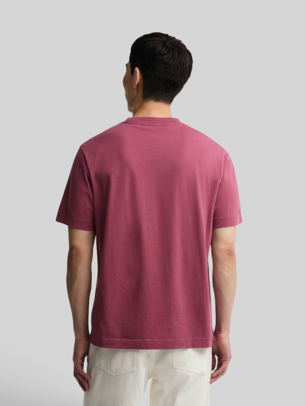 Back view of a man wearing a maroon Baffle Haus Eric graphic cotton t-shirt with a relaxed fit.